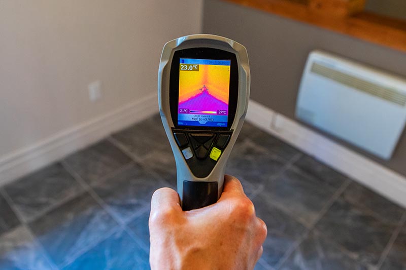 Thermal imaging device being used while preforming home inspection services 